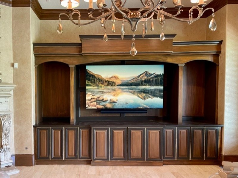 TV and soundbar mounted in custom wood built-in cabinet