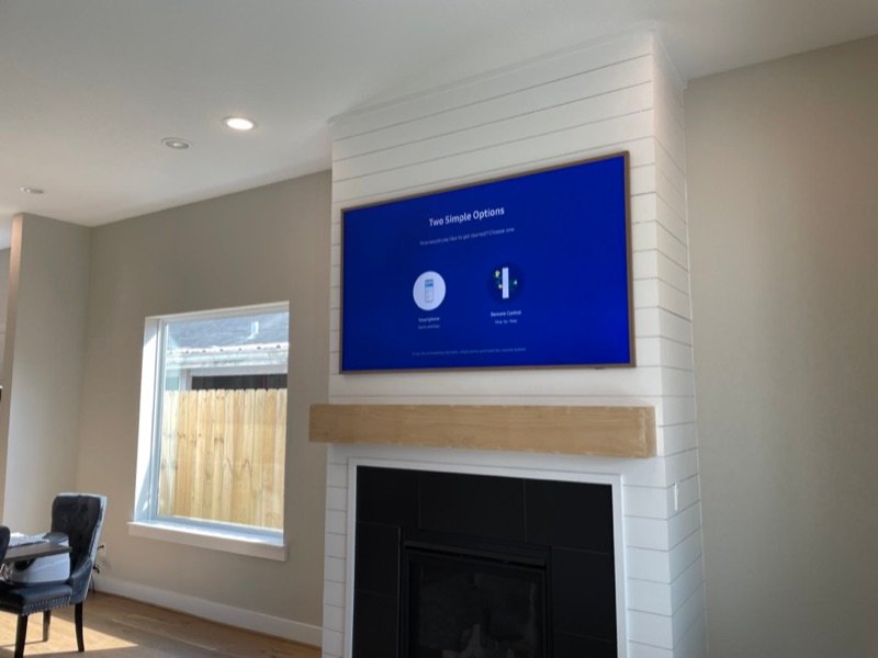 Samsung Frame TV mounted on white shiplap fireplace